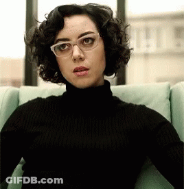 Woman In Glasses And Black Turtleneck GIF