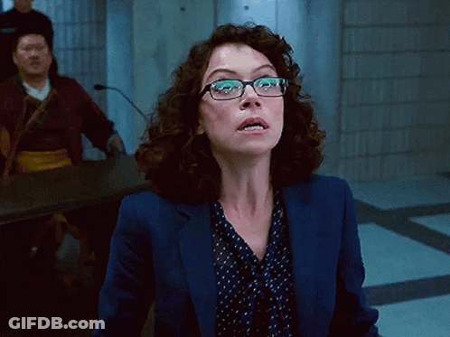 Woman In Glasses And Blue Jacket Looking Up GIF