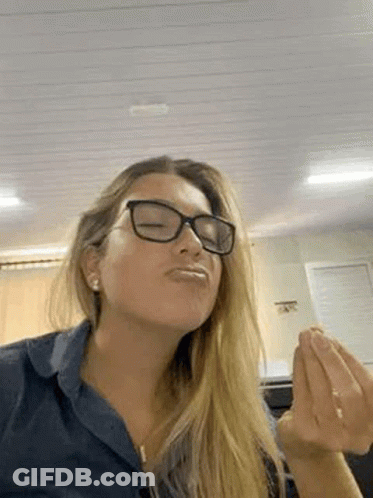 Woman In Glasses And Blue Shirt Making A Face GIF
