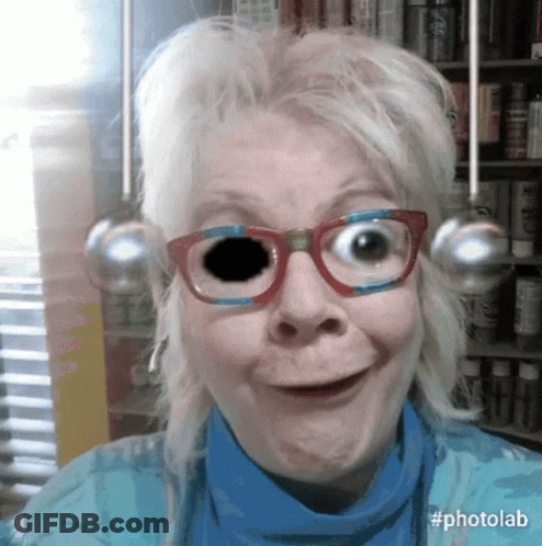 Woman In Glasses And Blue Shirt With Black Eye GIF