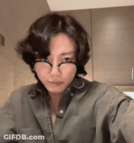 Woman In Glasses And Denim Shirt Taking Selfie GIF