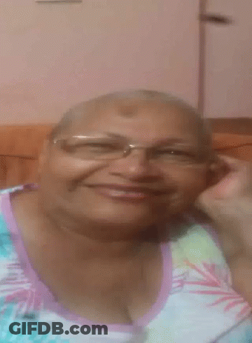 Woman In Glasses And Floral Shirt Smiling GIF