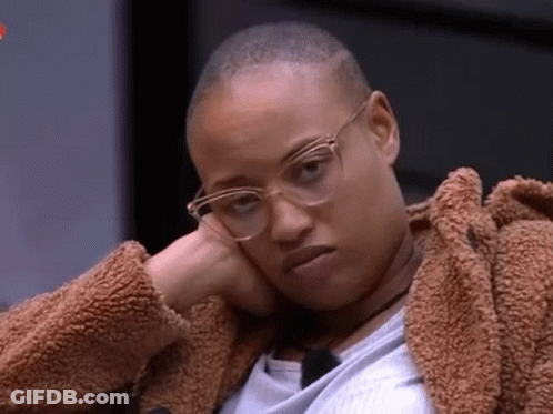 Woman In Glasses And Fur Coat With Hand On Face GIF