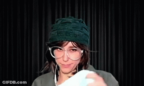 Woman In Glasses And Green Hat Smiling GIF