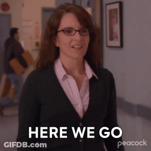 Woman In Glasses And Green Sweater Saying Here We Go GIF
