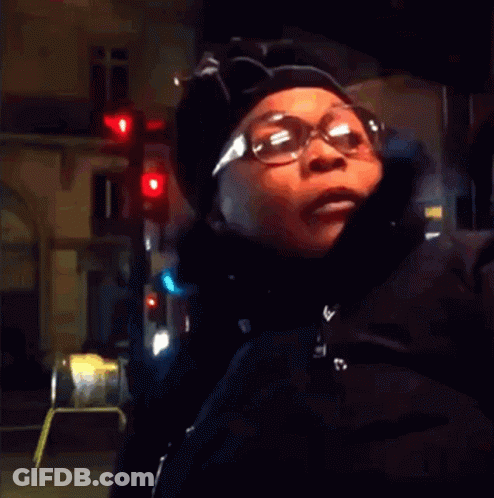 Woman In Glasses And Hat At Red Light GIF