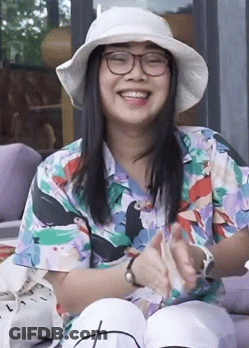 Woman In Glasses And Hat Smiling And Clapping GIF