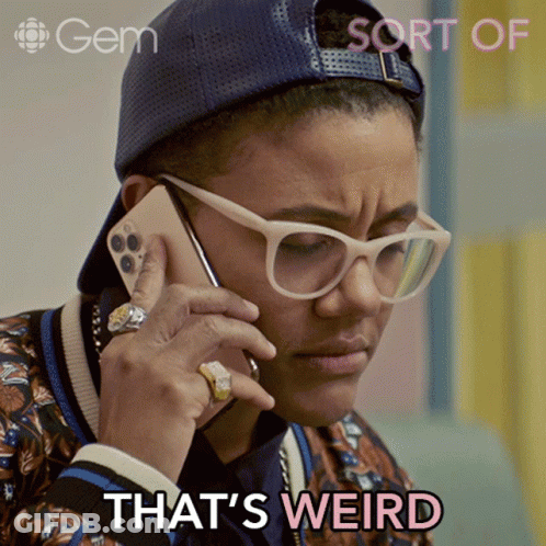 Woman In Glasses And Hat Talking On Phone Saying That's Weird GIF