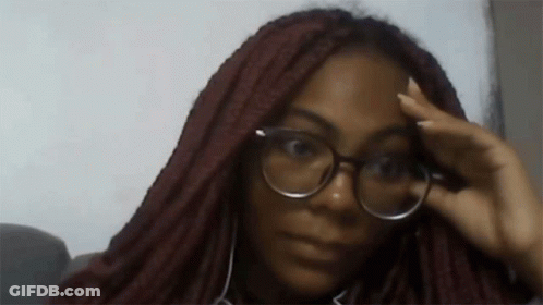 Woman In Glasses And Headphones Looking At Camera GIF