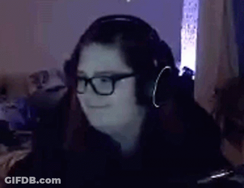 Woman In Glasses And Headphones Sitting In Dark Room GIF