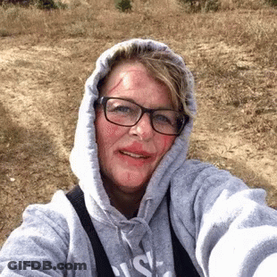 Woman In Glasses And Hoodie With Blood On Face GIF