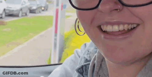 Woman In Glasses And Hoop Earrings Smiling GIF