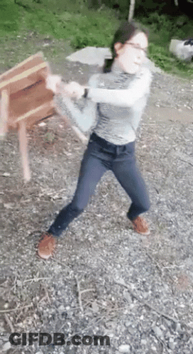 Woman In Glasses And Jeans Throwing Chair GIF