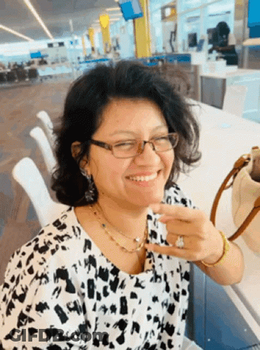 Woman In Glasses And Leopard Print Shirt Smiling GIF