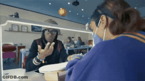 Woman In Glasses And Mask Looking In Mirror GIF