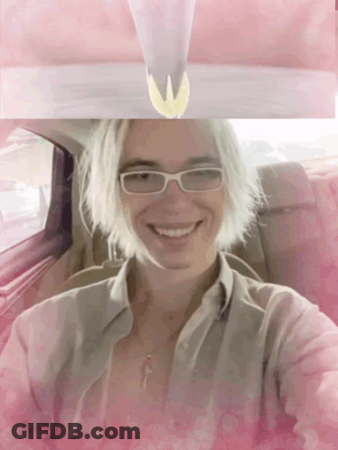 Woman In Glasses And Necklace Smiling In Car GIF