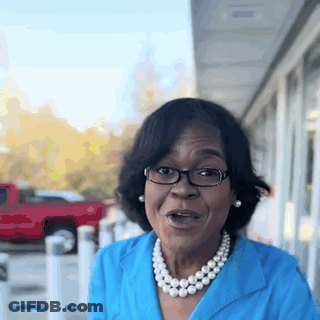 Woman In Glasses And Pearl Necklace By Red Truck GIF