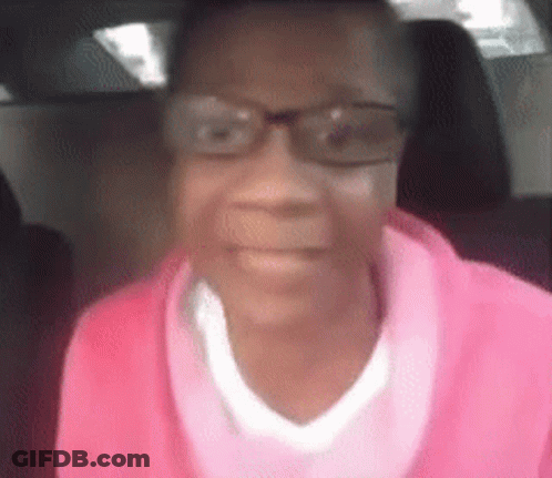Woman In Glasses And Pink Sweater Sitting In Car GIF