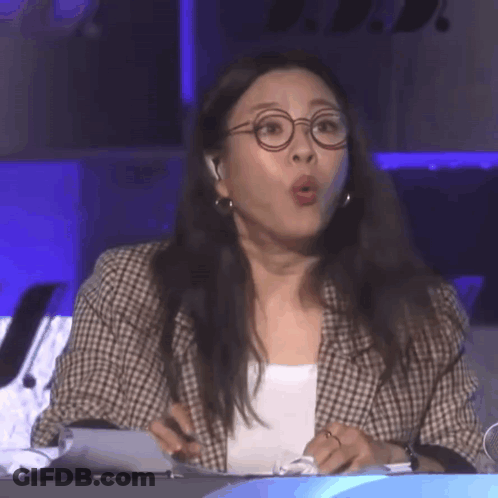 Woman In Glasses And Plaid Jacket Mouth Open GIF