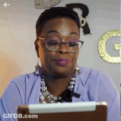 Woman In Glasses And Purple Shirt Looking At Tablet GIF