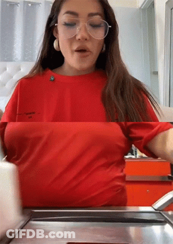 Woman In Glasses And Red Shirt At Counter GIF