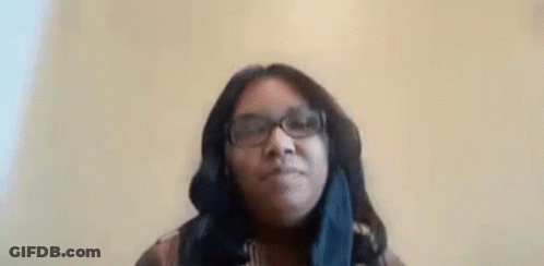 Woman In Glasses And Scarf Making Funny Face GIF