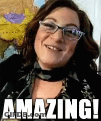 Woman In Glasses And Scarf Smiling Saying Amazing GIF