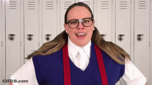 Woman In Glasses And Sweater Vest By Lockers GIF