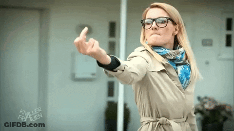 Woman In Glasses And Trench Coat Showing Middle Finger GIF