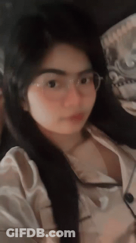 Woman In Glasses And White Shirt Looking At Camera GIF