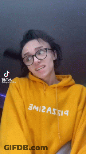 Woman In Glasses And Yellow Hoodie With TikTok Icon GIF