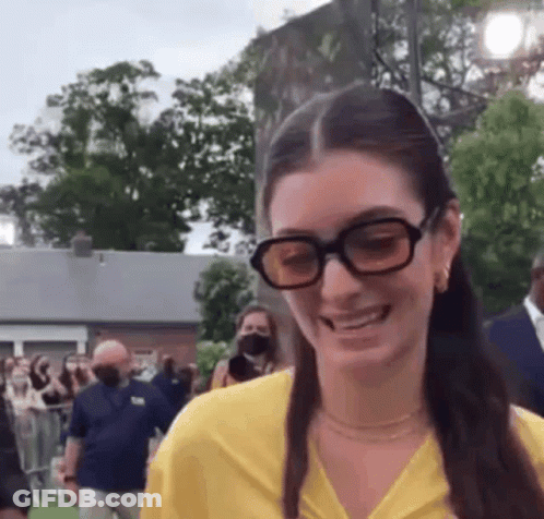Woman In Glasses And Yellow Shirt Smiling GIF