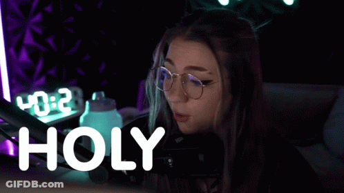 Woman In Glasses At Microphone Saying Holy GIF