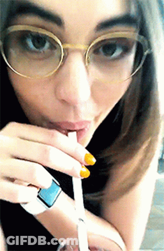 Woman In Glasses Drinking Through Straw GIF