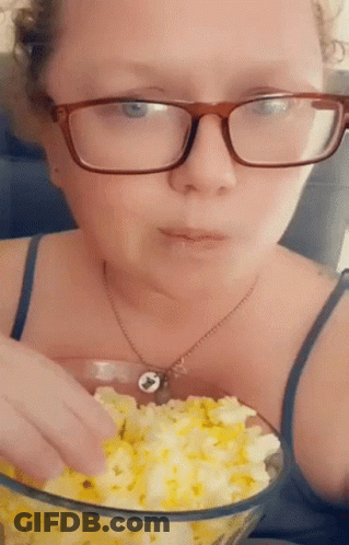 Woman In Glasses Eating Popcorn GIF