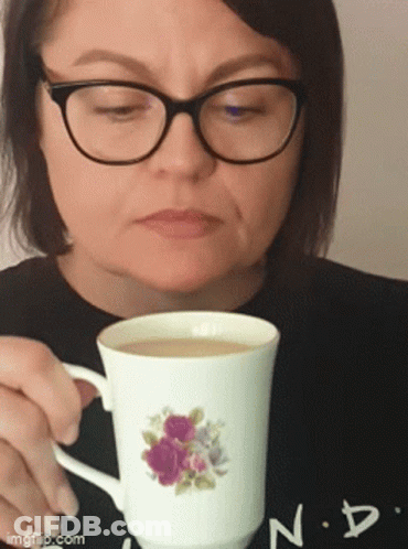 Woman In Glasses Holding Floral Coffee Cup GIF