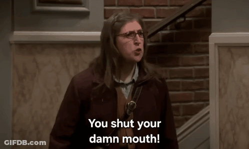 Woman In Glasses In Front Of Brick Wall Says You Shut Your Damn Mouth GIF
