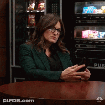 Woman In Glasses Looking At Phone GIF