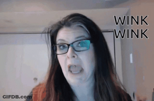 Woman In Glasses Making Funny Face Wink Wink GIF