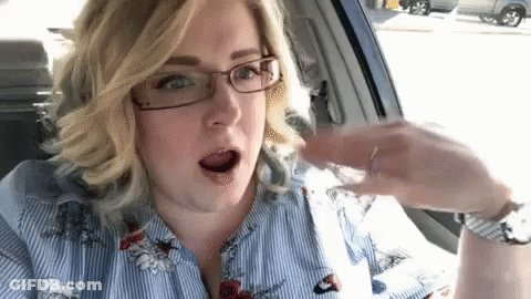 Woman In Glasses Sitting In Car Holding Water GIF