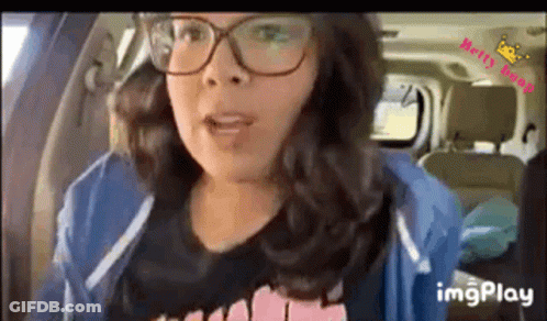 Woman In Glasses Sitting In Car Talking GIF