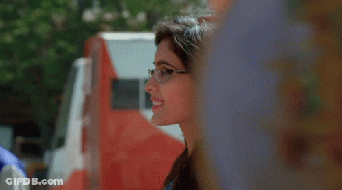 Woman In Glasses Smiling By Red And White Truck GIF