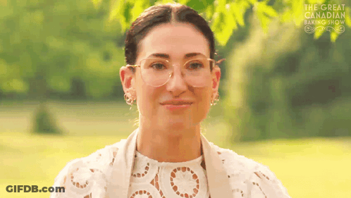 Woman In Glasses Smiling In Field GIF