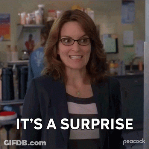 Woman In Glasses Smiling Saying It's A Surprise GIF