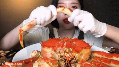 Woman In Gloves Eating Large Crab GIF