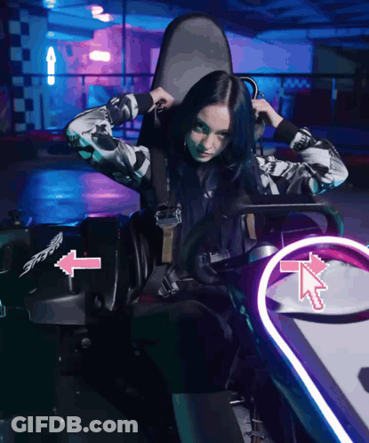 Woman In Go Kart With Pink Arrow Pointing Left GIF