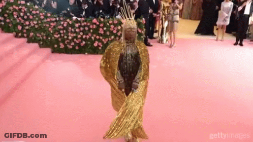 Woman In Gold Dress And Crown GIF