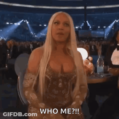 Woman In Gold Dress Asking Who Me GIF