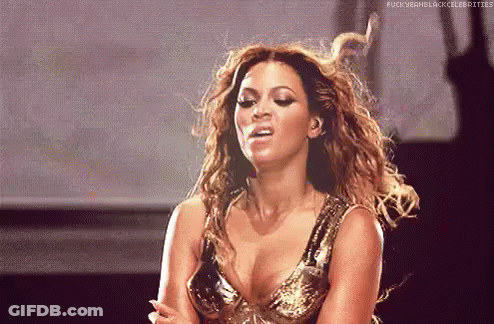 Woman In Gold Dress Making Funny Face On Stage GIF