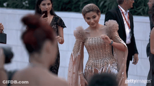 Woman In Gold Dress Photographed By Getty Photographer GIF
